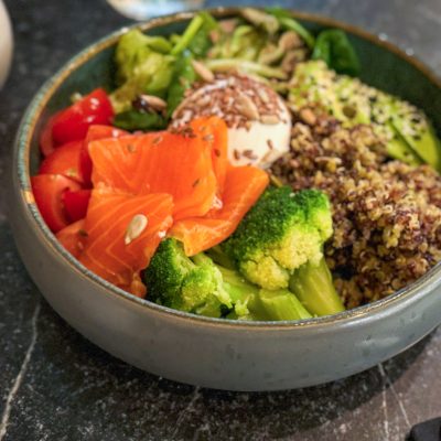Colorful salmon poke bowl with quinoa, avocado, and vegetables
